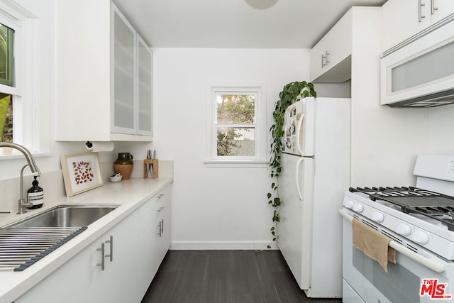 kitchen featuring white cabinetry, sink, white appliances, and dark wood-type flooring