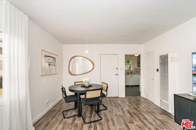 dining space featuring hardwood / wood-style flooring and sink