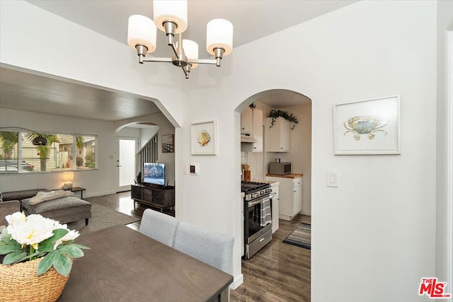 dining area with a chandelier and dark hardwood / wood-style floors