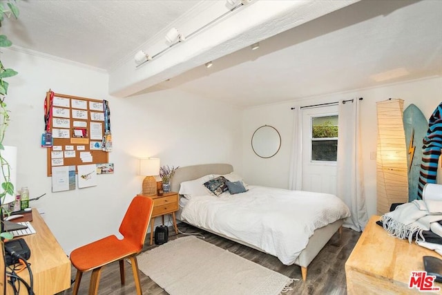 bedroom featuring dark hardwood / wood-style floors and ornamental molding