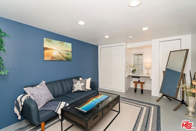 living room featuring concrete flooring