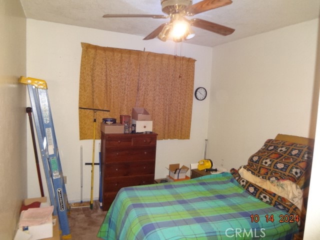 bedroom featuring ceiling fan and carpet