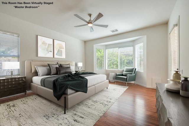 bedroom with ceiling fan and hardwood / wood-style flooring