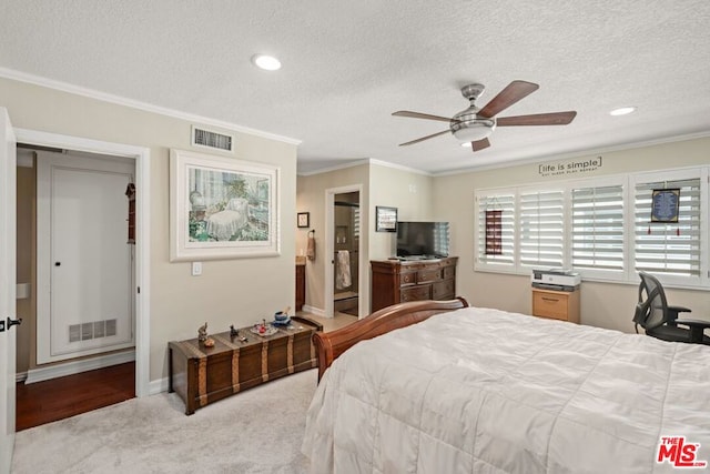 carpeted bedroom with ceiling fan, a textured ceiling, and ornamental molding