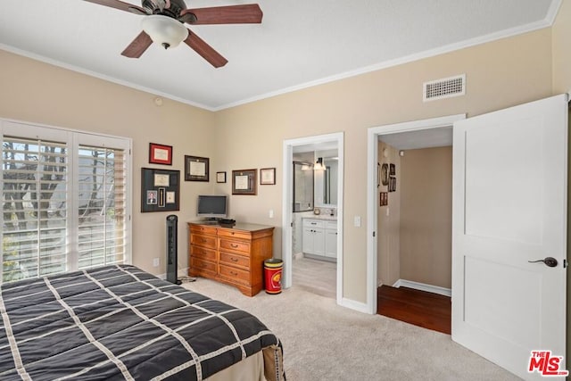 carpeted bedroom featuring ceiling fan, ornamental molding, and ensuite bath