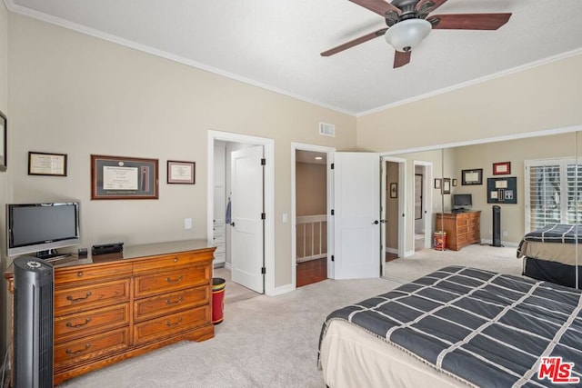 bedroom featuring connected bathroom, light colored carpet, and ceiling fan