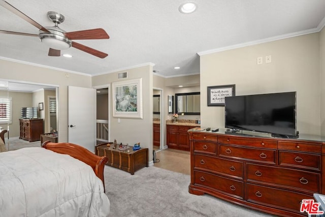 carpeted bedroom featuring connected bathroom, ceiling fan, and crown molding