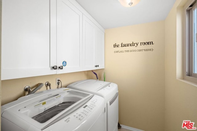 laundry room featuring cabinets and washing machine and clothes dryer