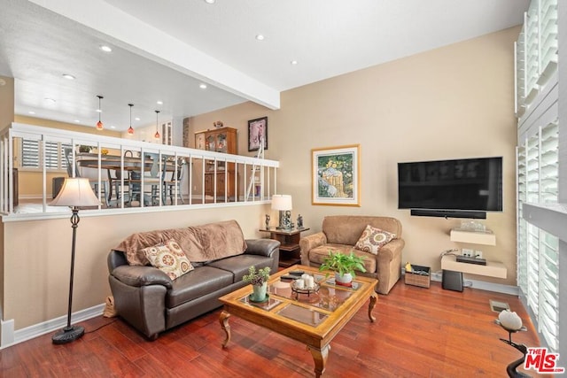 living room with beamed ceiling, hardwood / wood-style flooring, and plenty of natural light