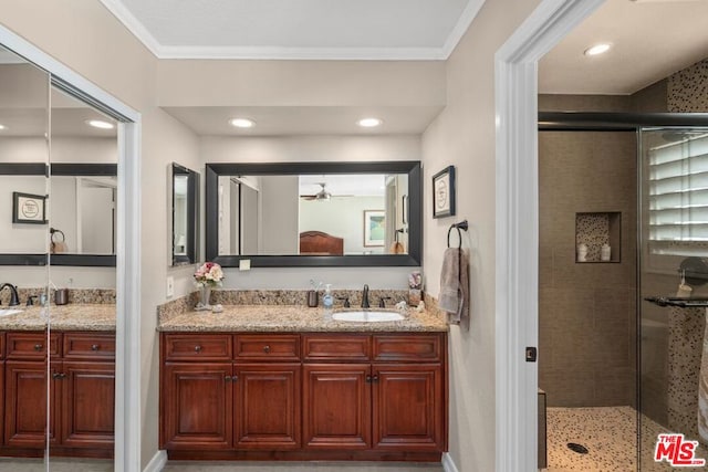 bathroom featuring walk in shower, crown molding, vanity, and ceiling fan