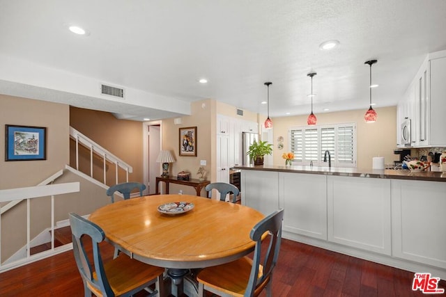 dining space featuring dark hardwood / wood-style flooring and sink