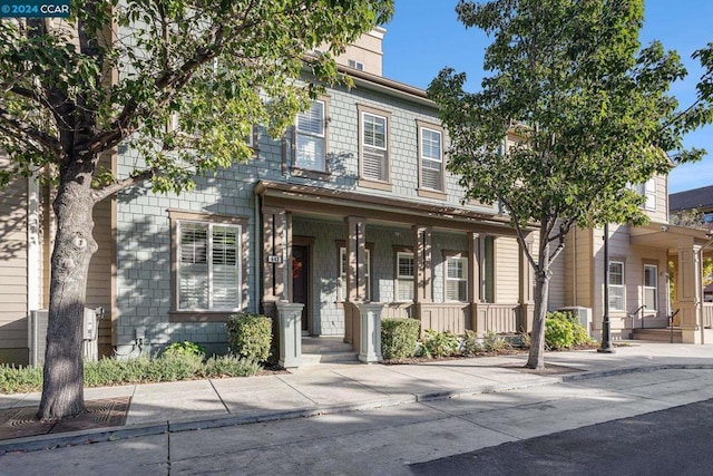 view of front of property featuring cooling unit and covered porch