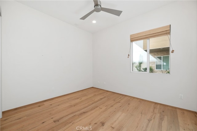 spare room featuring light hardwood / wood-style floors and ceiling fan