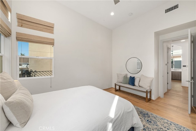 bedroom featuring multiple windows and hardwood / wood-style floors