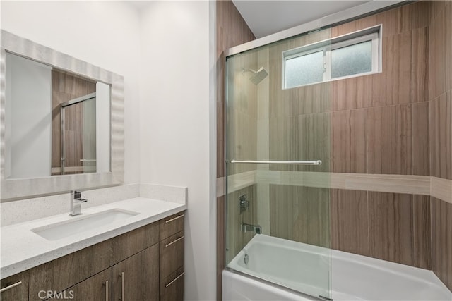 bathroom featuring vanity and combined bath / shower with glass door