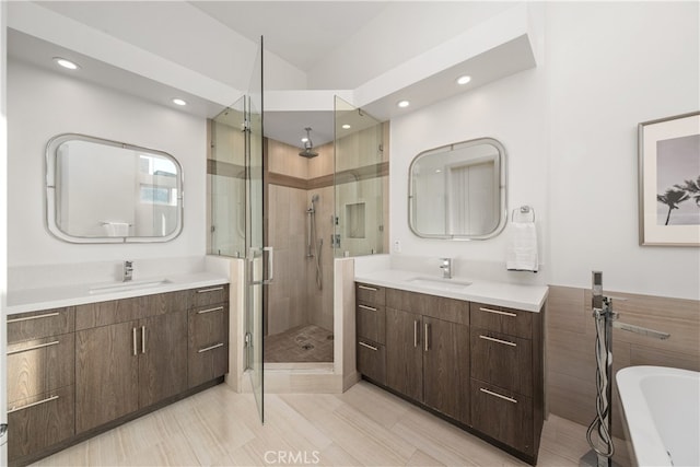 bathroom featuring vanity and separate shower and tub