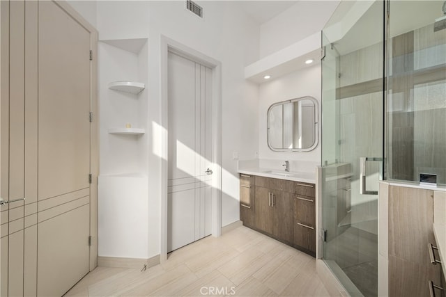 bathroom featuring vanity and an enclosed shower