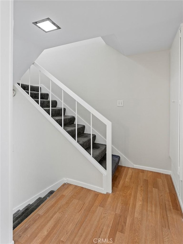 stairway with hardwood / wood-style floors