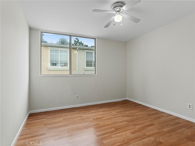 spare room featuring ceiling fan and light hardwood / wood-style flooring