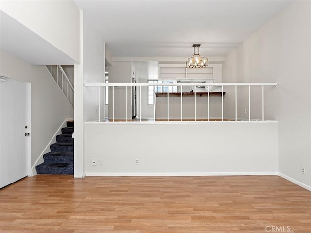 interior space featuring an inviting chandelier and light hardwood / wood-style flooring