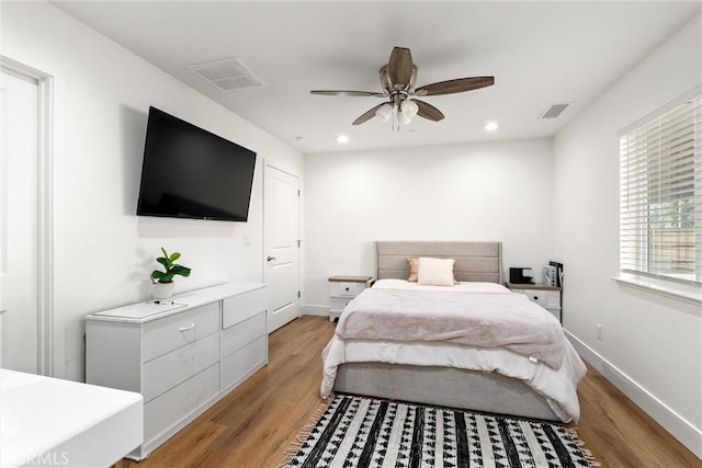 bedroom featuring light hardwood / wood-style floors and ceiling fan