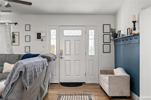 foyer featuring ceiling fan, plenty of natural light, and hardwood / wood-style flooring