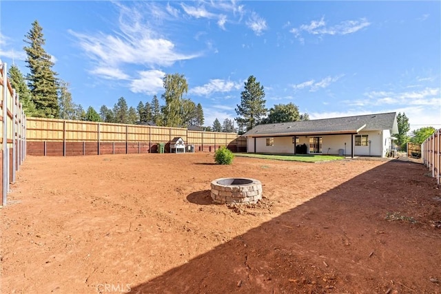 view of yard with an outdoor fire pit