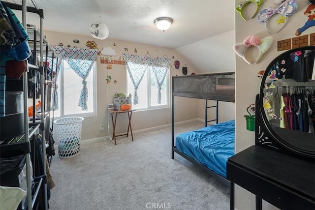 carpeted bedroom with lofted ceiling