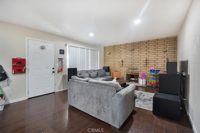 living room with a fireplace and dark hardwood / wood-style floors