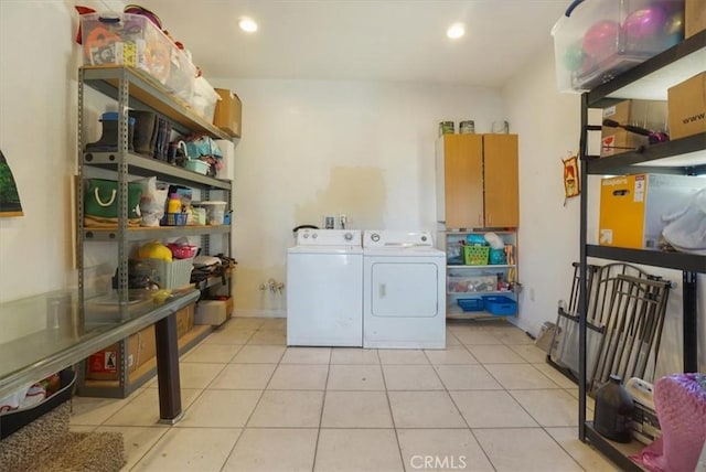 washroom featuring washing machine and clothes dryer and light tile patterned floors