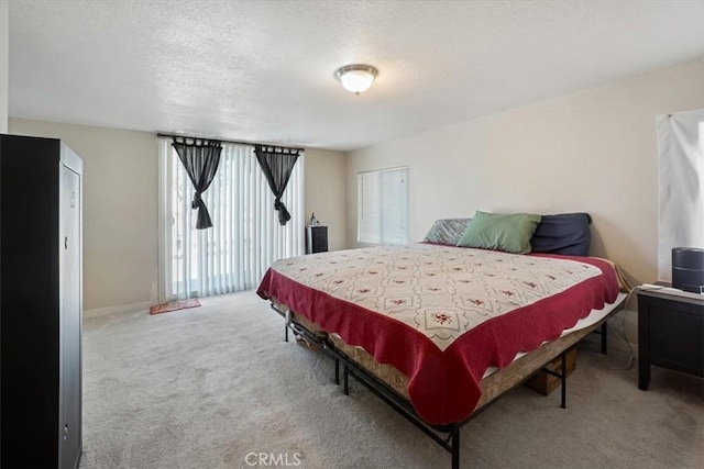 carpeted bedroom featuring a textured ceiling