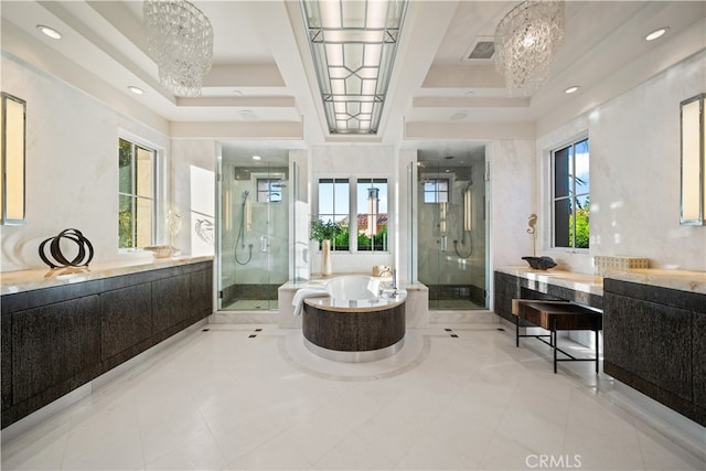 bathroom featuring an inviting chandelier, shower with separate bathtub, and a tray ceiling