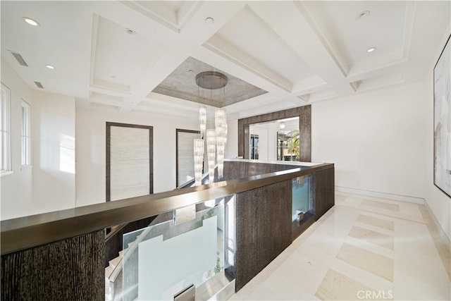 kitchen featuring coffered ceiling, beamed ceiling, a chandelier, and pendant lighting