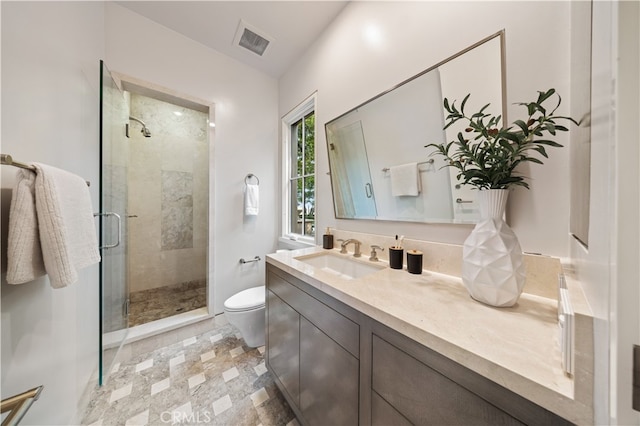 bathroom featuring vanity, toilet, and walk in shower