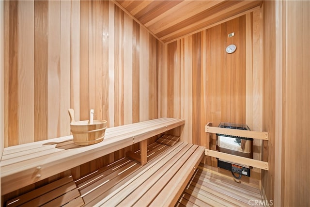 view of sauna featuring wooden walls and wooden ceiling