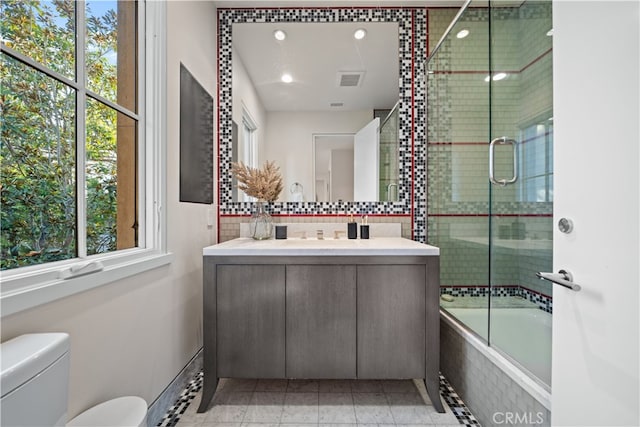 full bathroom with vanity, toilet, tile patterned floors, and combined bath / shower with glass door