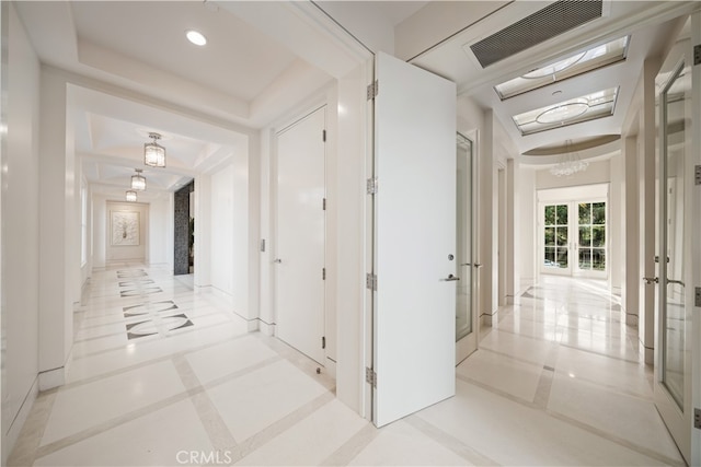 hall with french doors and light tile patterned floors