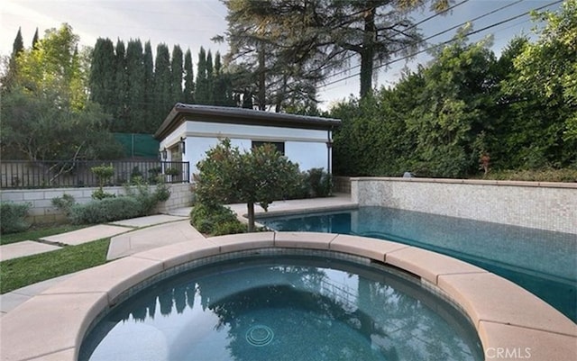 view of swimming pool featuring an in ground hot tub