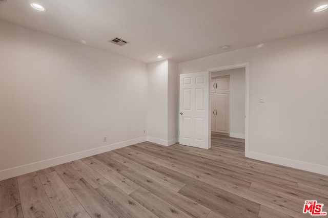 spare room with light hardwood / wood-style floors