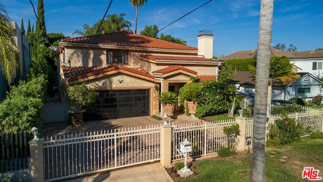 mediterranean / spanish-style house with a garage