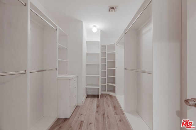 walk in closet featuring light hardwood / wood-style flooring