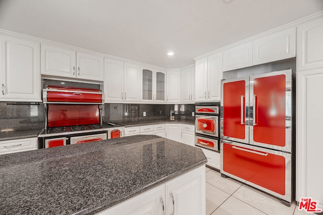 kitchen with appliances with stainless steel finishes, tasteful backsplash, and white cabinetry