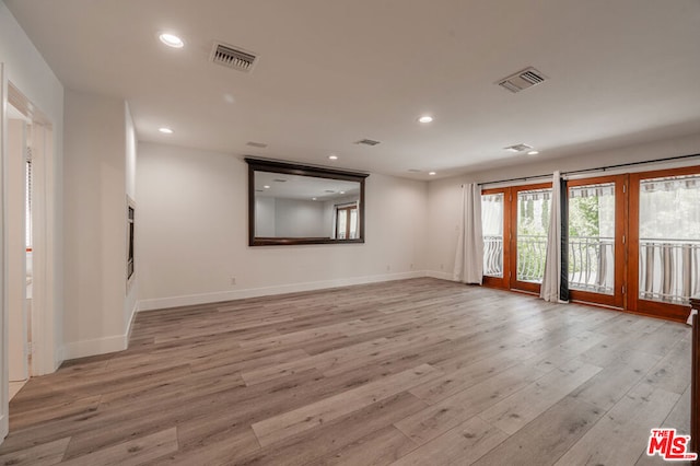 spare room with light hardwood / wood-style flooring