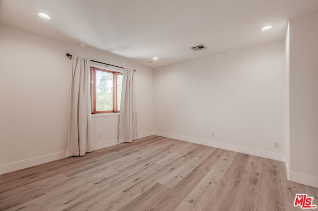 unfurnished room featuring light hardwood / wood-style floors