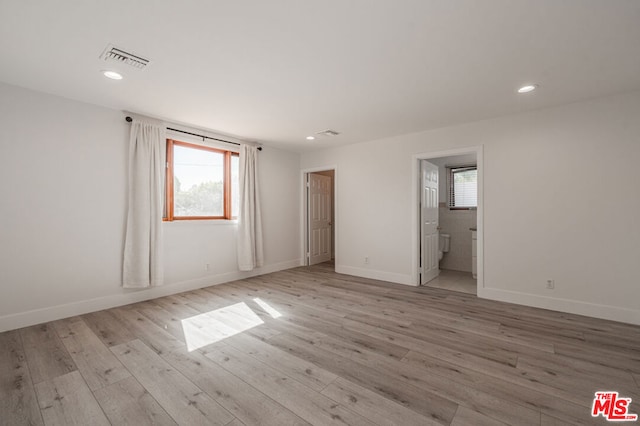 spare room featuring light wood-type flooring