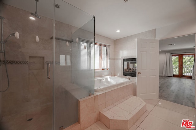 bathroom featuring separate shower and tub and tile patterned flooring