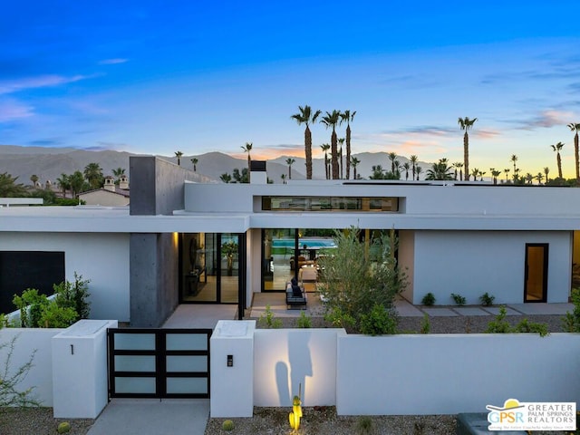 view of front of property featuring a patio and a mountain view