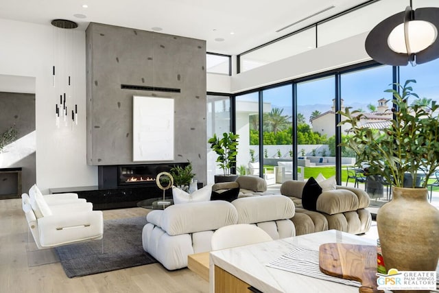 living room featuring a fireplace and light wood-type flooring