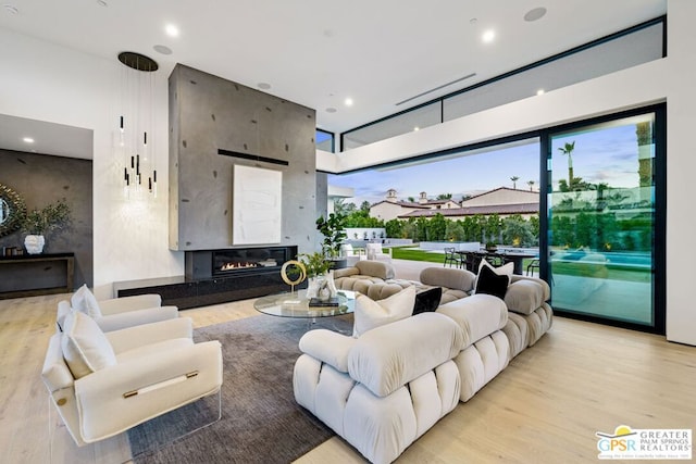 living room featuring light hardwood / wood-style flooring and a fireplace