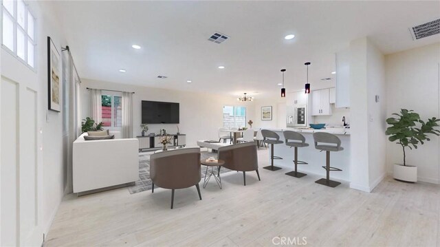 living room with light wood-type flooring and sink